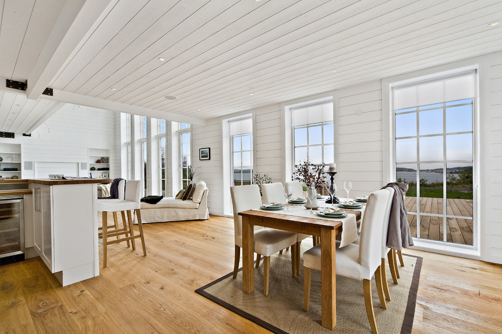 Свежая идея для дизайна: гостиная-столовая среднего размера в стиле кантри с белыми стенами и паркетным полом среднего тона без камина - отличное фото интерьера