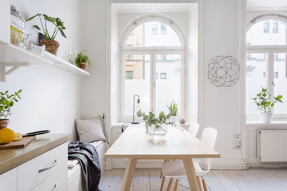 Inspiration for a mid-sized scandinavian light wood floor great room remodel in Stockholm with white walls