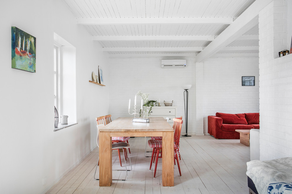Mid-sized danish light wood floor great room photo in Malmo with white walls
