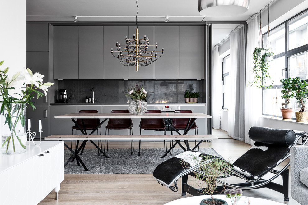 Inspiration for a large scandinavian kitchen/dining room in Stockholm with grey walls and light hardwood flooring.