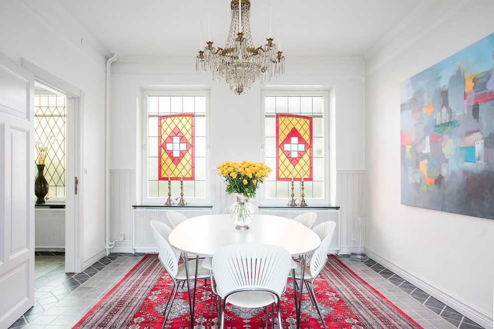 Photo of a large scandinavian enclosed dining room in Malmo with white walls.