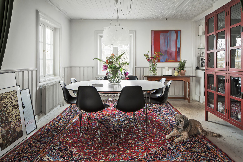 Medium sized scandinavian dining room in Stockholm with white walls, light hardwood flooring and no fireplace.