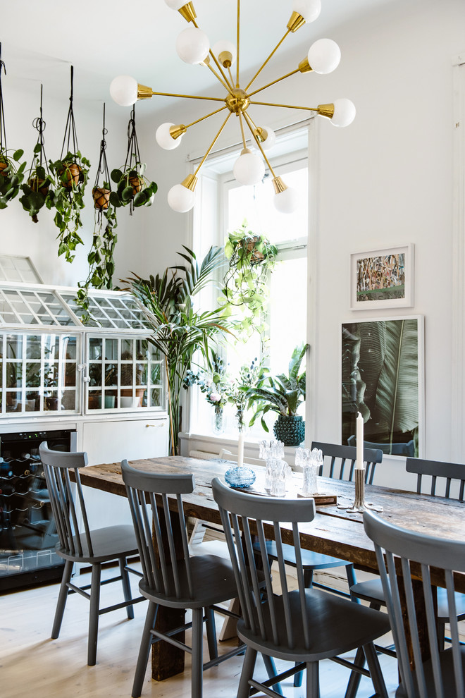Dining room - eclectic light wood floor and beige floor dining room idea in Stockholm with white walls and no fireplace