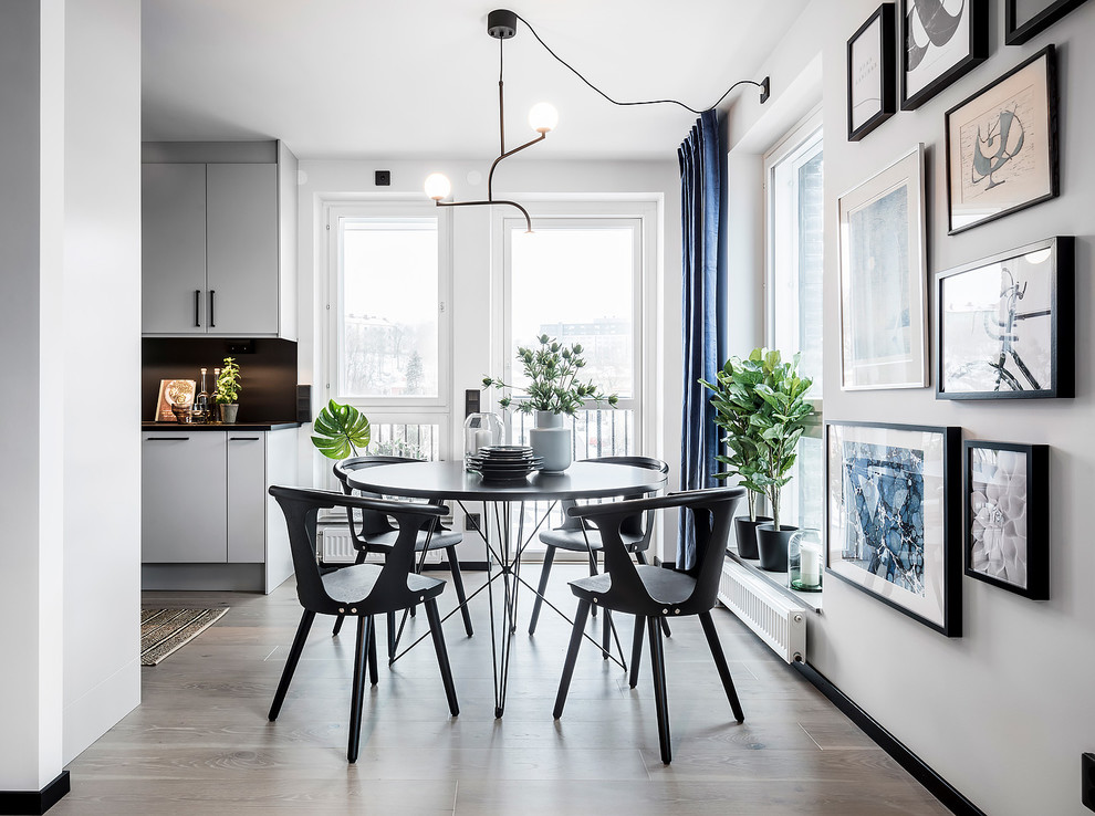 Inspiration for a large scandinavian open plan dining room in Gothenburg with white walls, light hardwood flooring, no fireplace and grey floors.