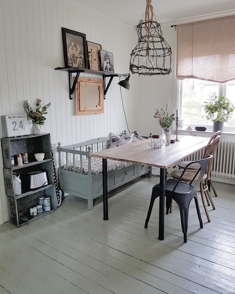 Dining room - mid-sized shabby-chic style painted wood floor dining room idea in Gothenburg with white walls