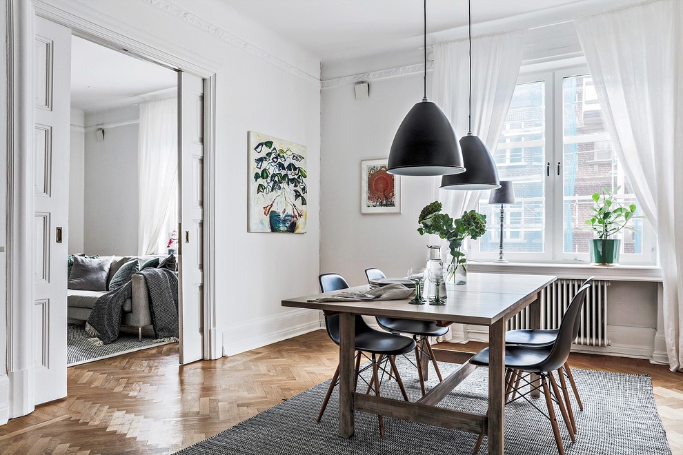 Design ideas for a large scandinavian enclosed dining room in Malmo with white walls, medium hardwood flooring and brown floors.