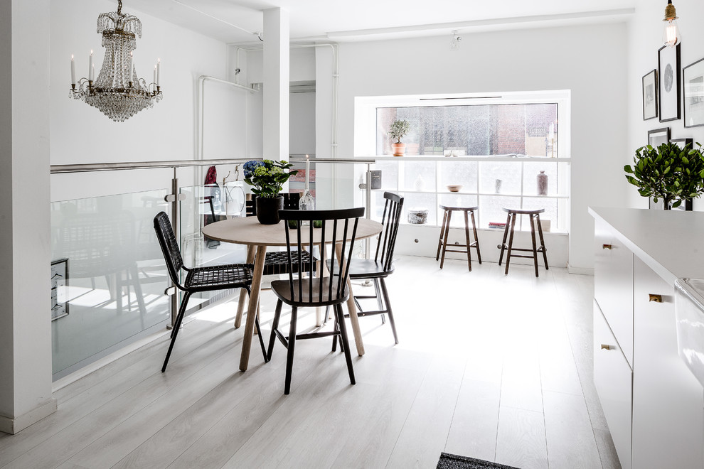 Inspiration for a medium sized contemporary dining room in Gothenburg with white walls, painted wood flooring and no fireplace.