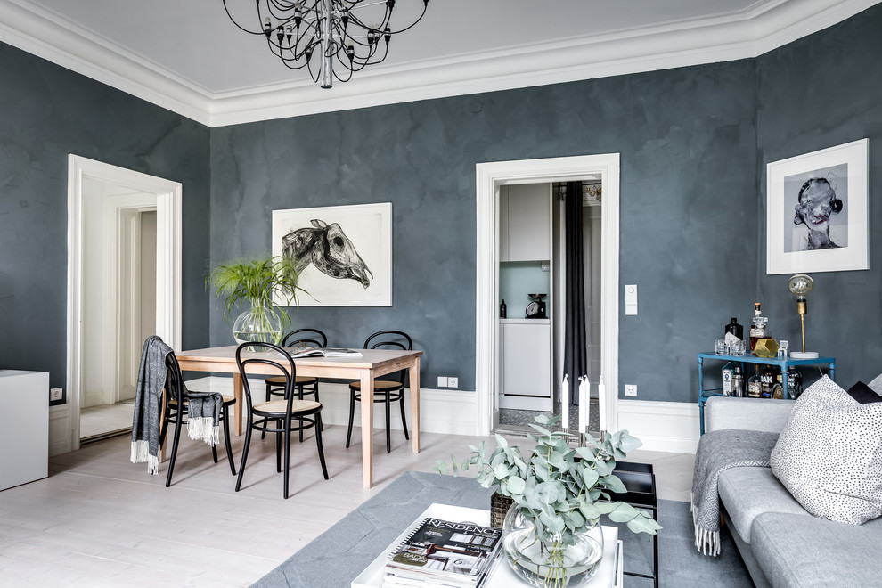 Large scandinavian dining room in Stockholm with grey walls, light hardwood flooring, no fireplace and white floors.
