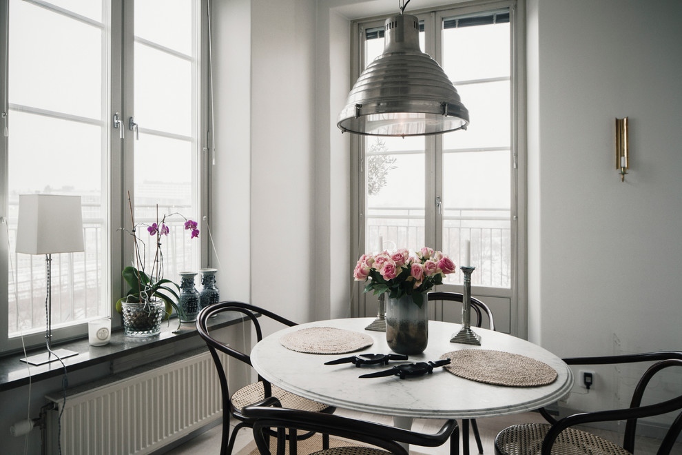 Large modern open plan dining room in Stockholm with white walls.