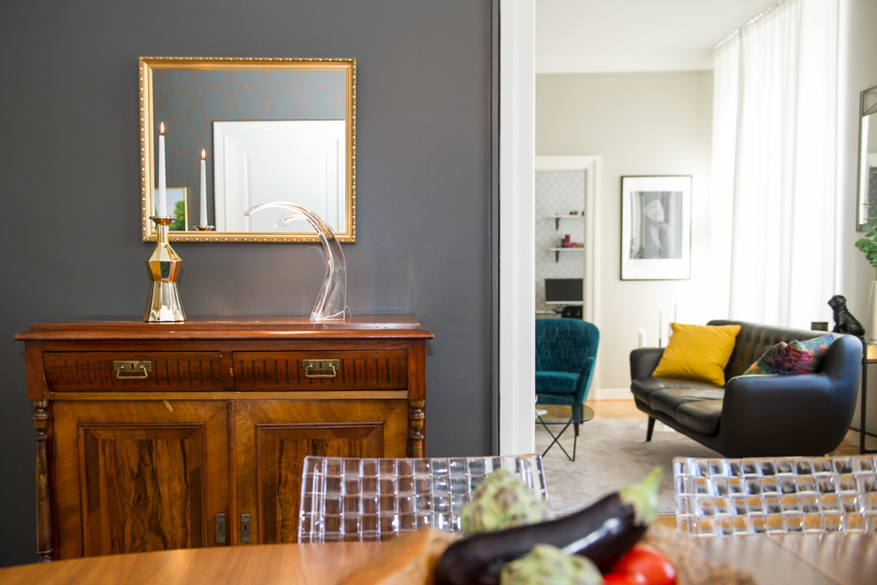 Photo of a medium sized eclectic enclosed dining room in Other with grey walls and dark hardwood flooring.