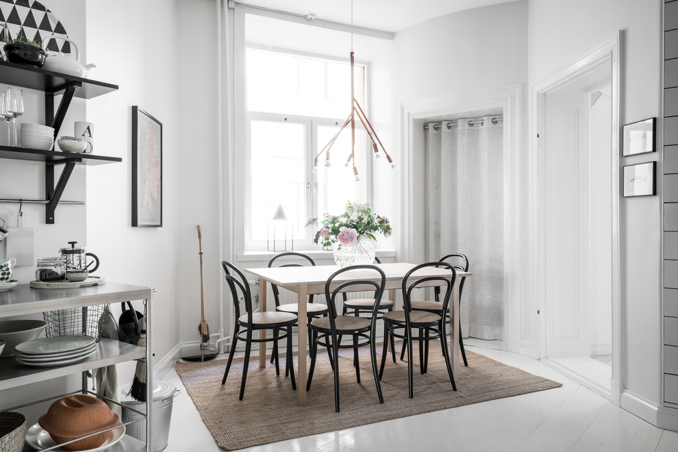 This is an example of a medium sized scandi kitchen/dining room in Gothenburg with white walls, painted wood flooring and white floors.