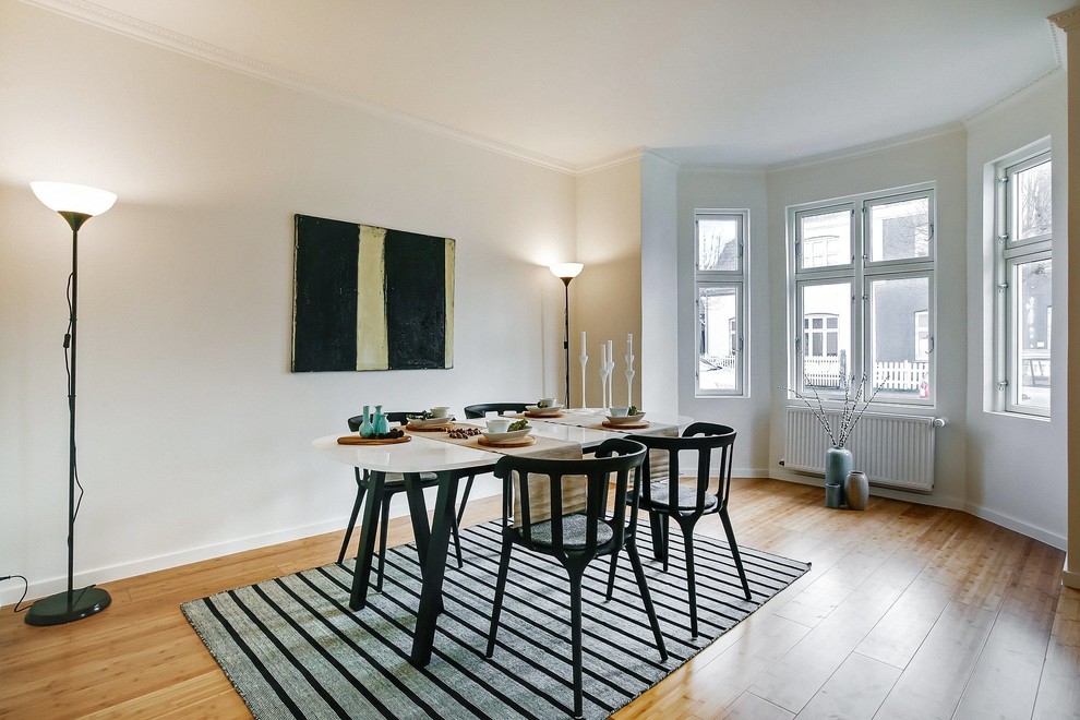 Medium sized scandi enclosed dining room in Other with white walls, light hardwood flooring and no fireplace.