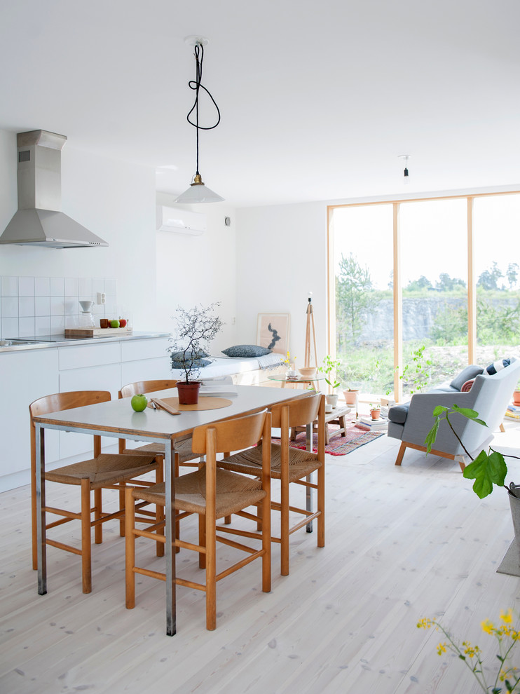 Design ideas for a small scandi dining room in Other with white walls, light hardwood flooring and no fireplace.