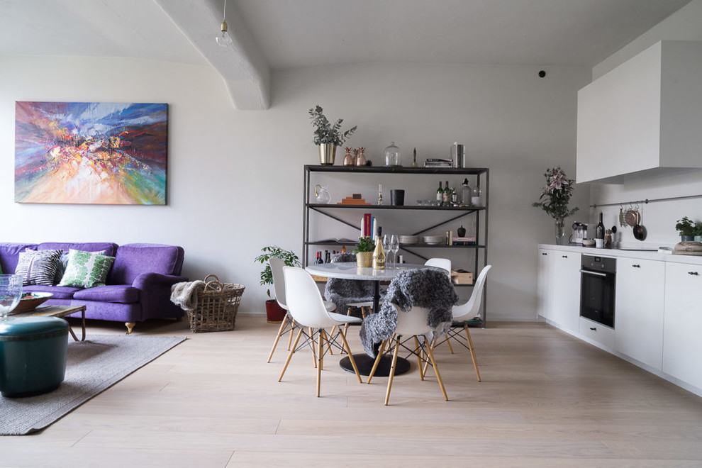 Photo of a medium sized eclectic dining room in Stockholm with white walls, light hardwood flooring and beige floors.