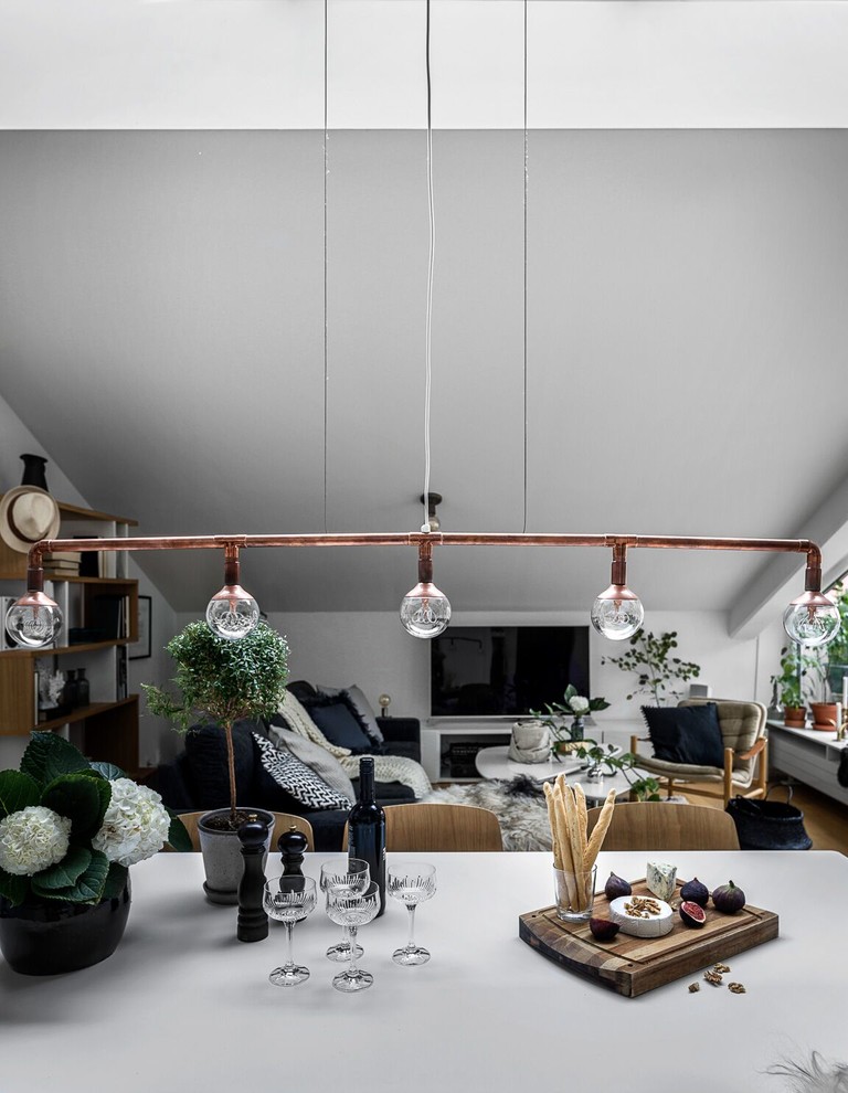 Inspiration for an industrial dining room in Stockholm with white walls.