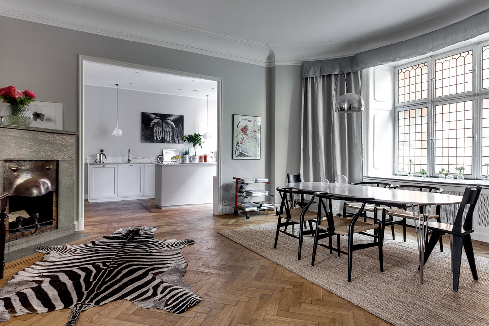 Inspiration for a mid-sized scandinavian light wood floor dining room remodel in Stockholm with gray walls and no fireplace