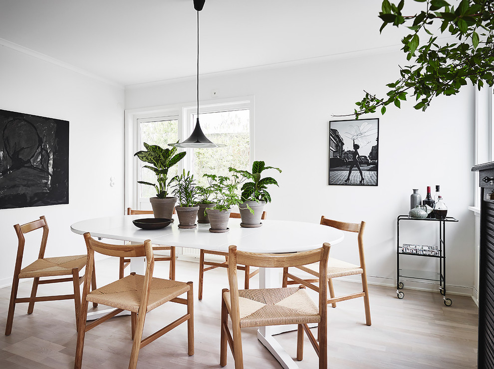 Inspiration for a scandinavian light wood floor and beige floor kitchen/dining room combo remodel in Gothenburg with white walls