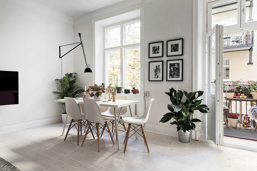 Imagen de comedor escandinavo de tamaño medio abierto sin chimenea con paredes blancas y suelo de madera pintada