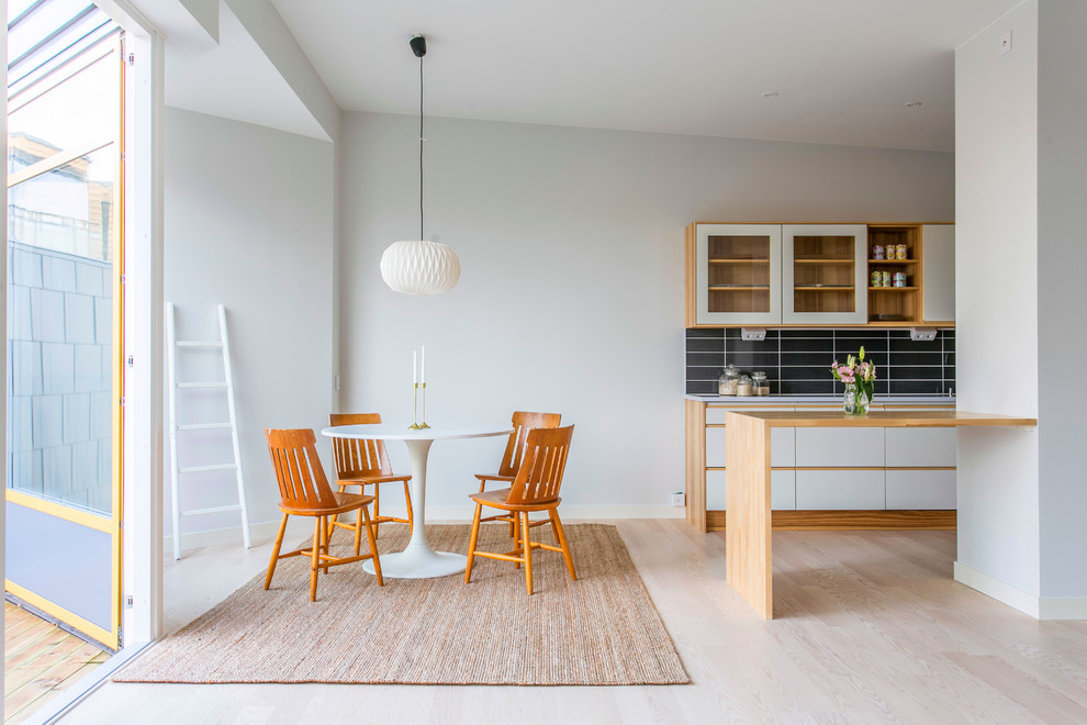 Inspiration for a medium sized scandi kitchen/dining room in Gothenburg with white walls, light hardwood flooring and no fireplace.