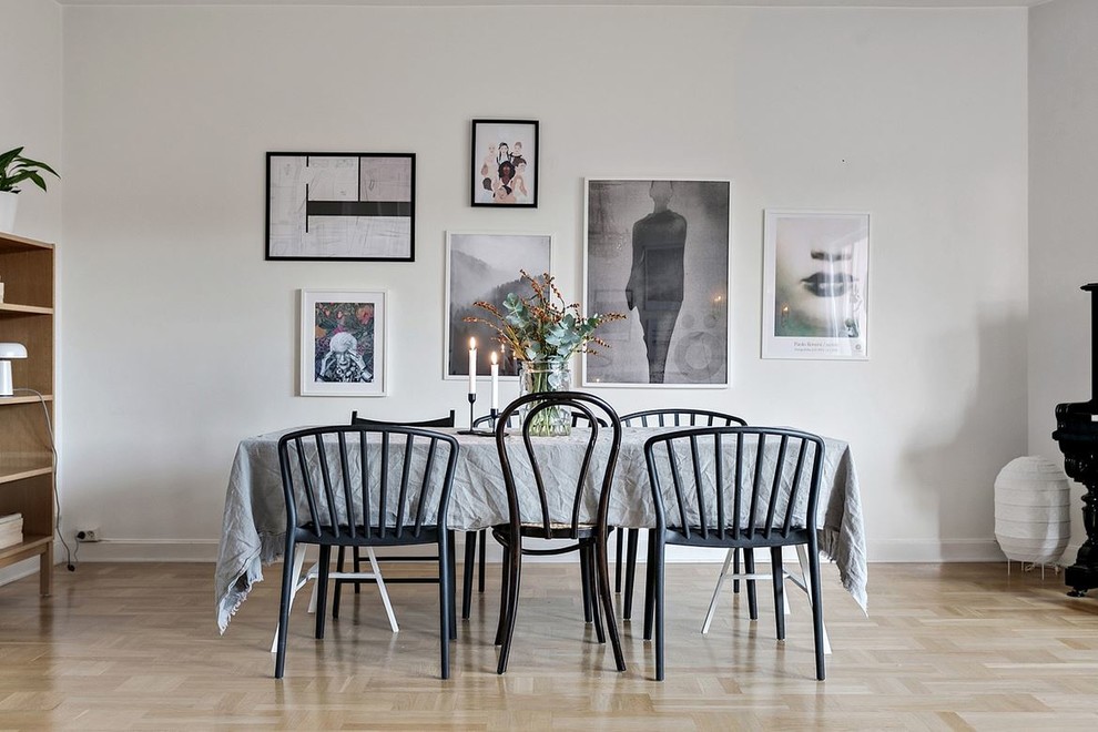 Design ideas for a scandi dining room with grey walls, light hardwood flooring and beige floors.
