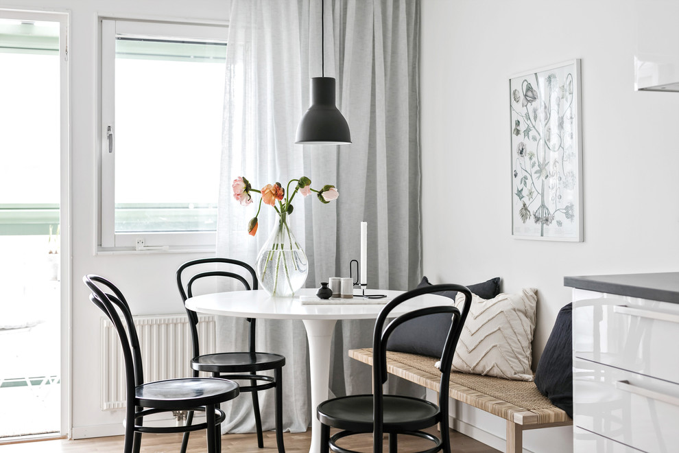 Kitchen/dining room combo - scandinavian kitchen/dining room combo idea in Gothenburg with white walls