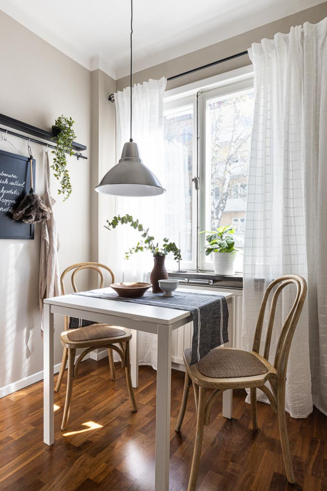 Inspiration for a small scandi dining room in Stockholm with grey walls, medium hardwood flooring and brown floors.
