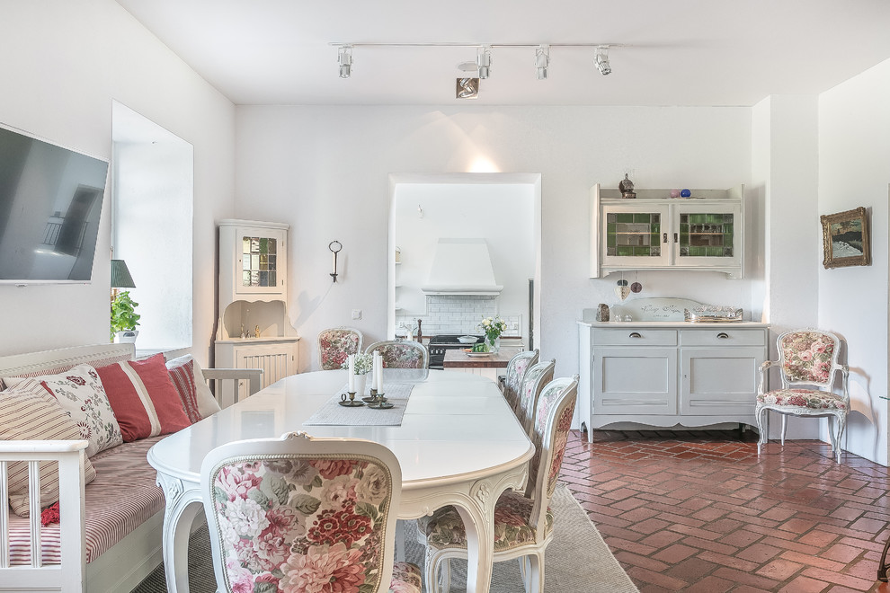 Enclosed dining room - large shabby-chic style brick floor and red floor enclosed dining room idea in Malmo with white walls and no fireplace