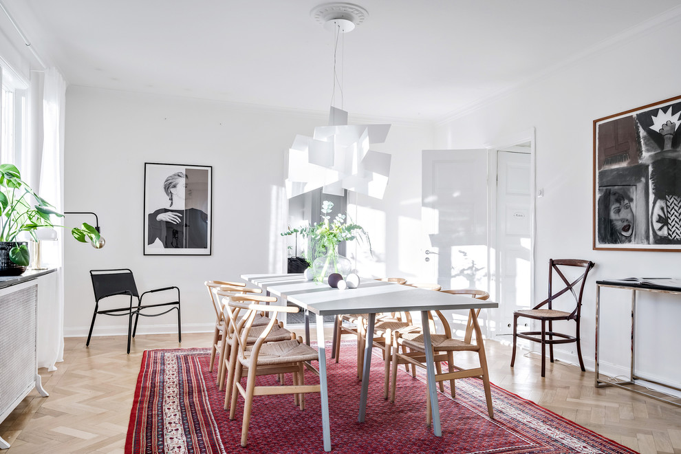 Design ideas for a medium sized scandinavian enclosed dining room in Gothenburg with white walls, light hardwood flooring and beige floors.