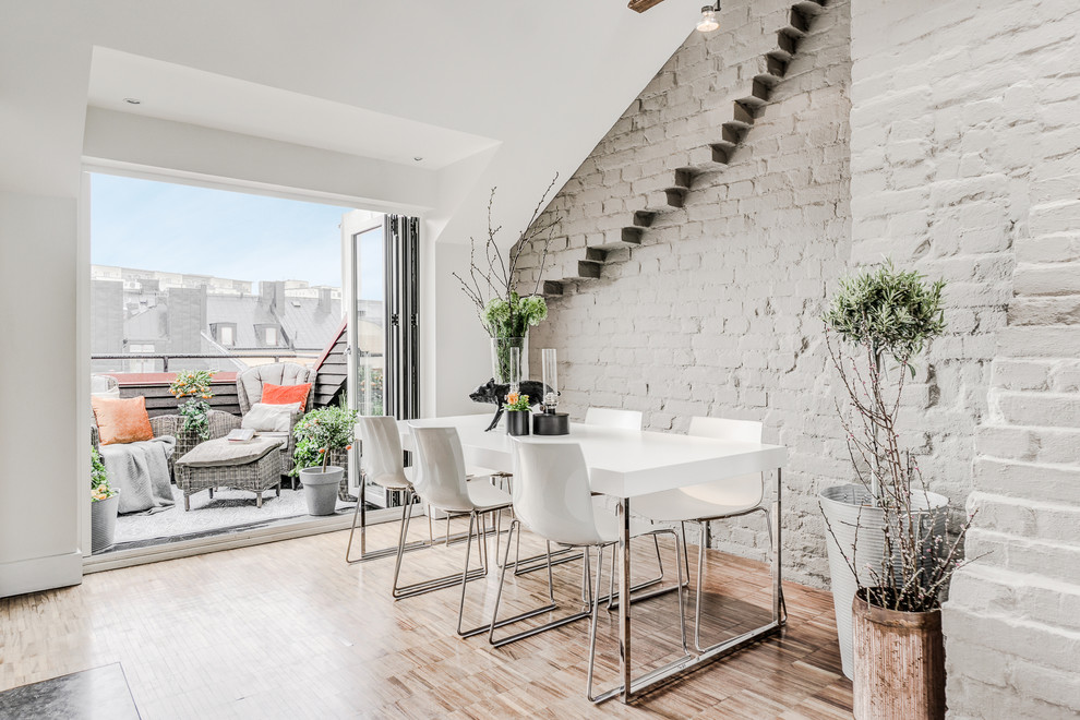 Example of a mid-sized danish light wood floor and brown floor great room design in Stockholm with no fireplace and gray walls
