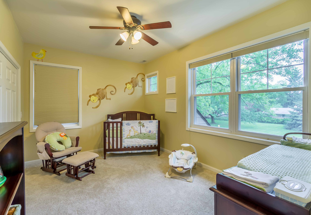 На фото: нейтральная комната для малыша среднего размера: освещение в стиле неоклассика (современная классика) с желтыми стенами, ковровым покрытием, бежевым полом, потолком с обоями и обоями на стенах с