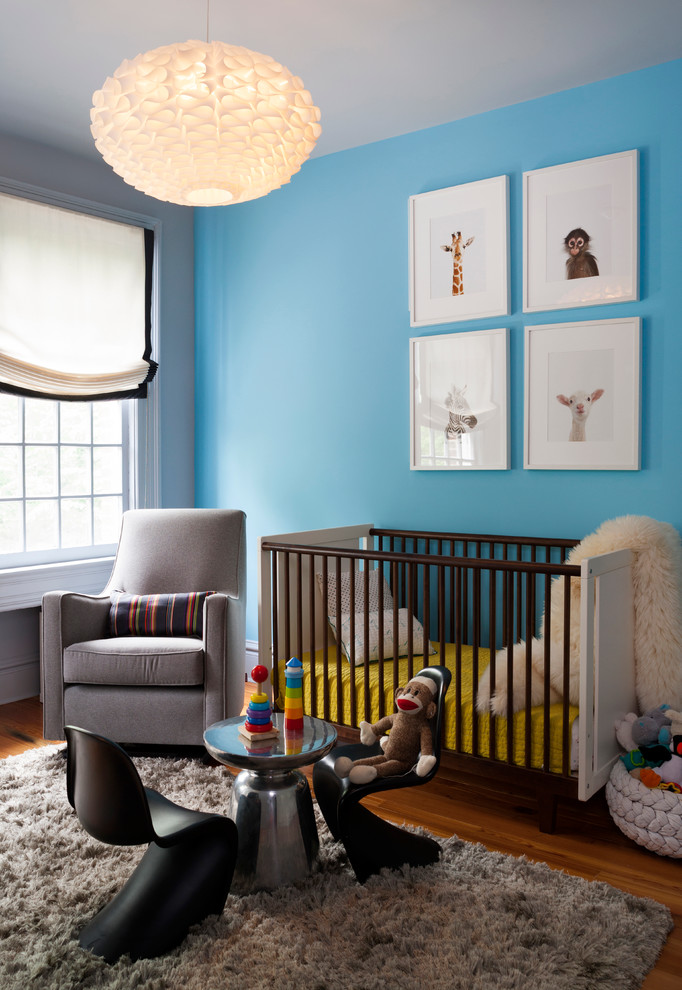 Medium sized contemporary nursery in DC Metro with blue walls and medium hardwood flooring.