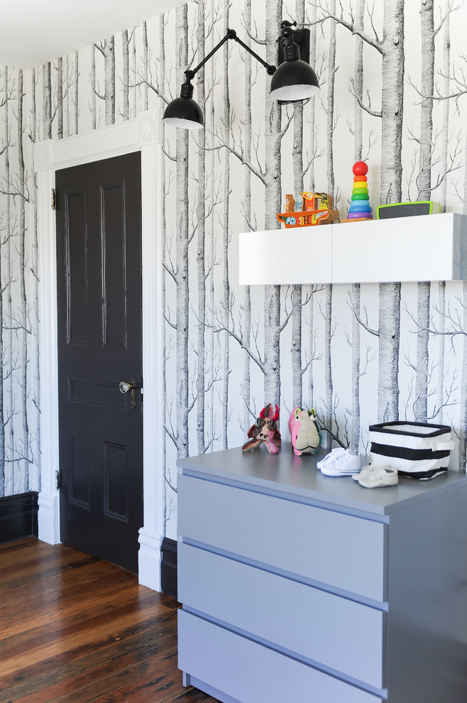 Mid-sized eclectic gender-neutral medium tone wood floor nursery photo in Vancouver with white walls