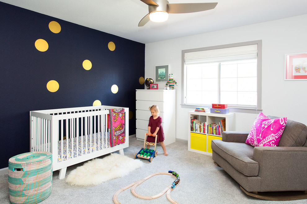 This is an example of a medium sized contemporary gender neutral nursery in San Francisco with white walls, carpet and grey floors.