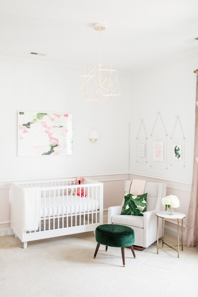 This is an example of a traditional nursery for girls in Raleigh with white walls, carpet, beige floors and a dado rail.