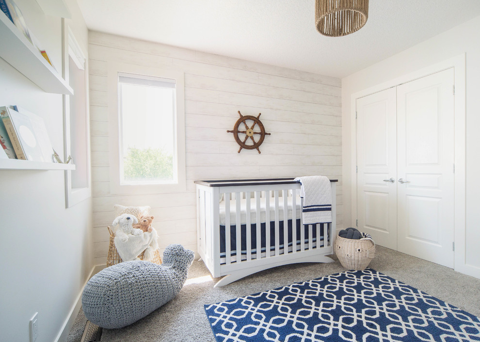 Inspiration for a medium sized beach style nursery for boys in Calgary with white walls, carpet and beige floors.