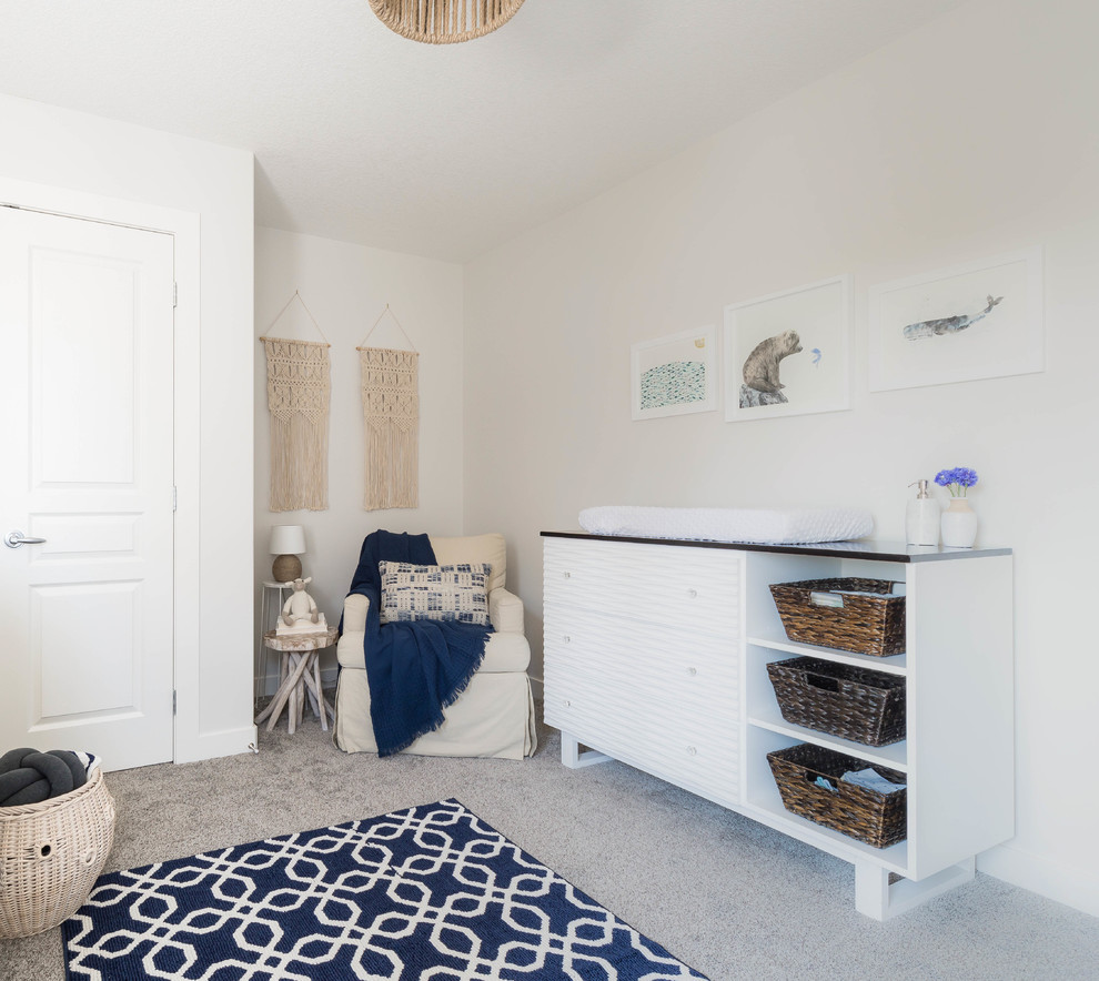 Immagine di una cameretta per neonato stile marinaro di medie dimensioni con pareti bianche, moquette e pavimento beige
