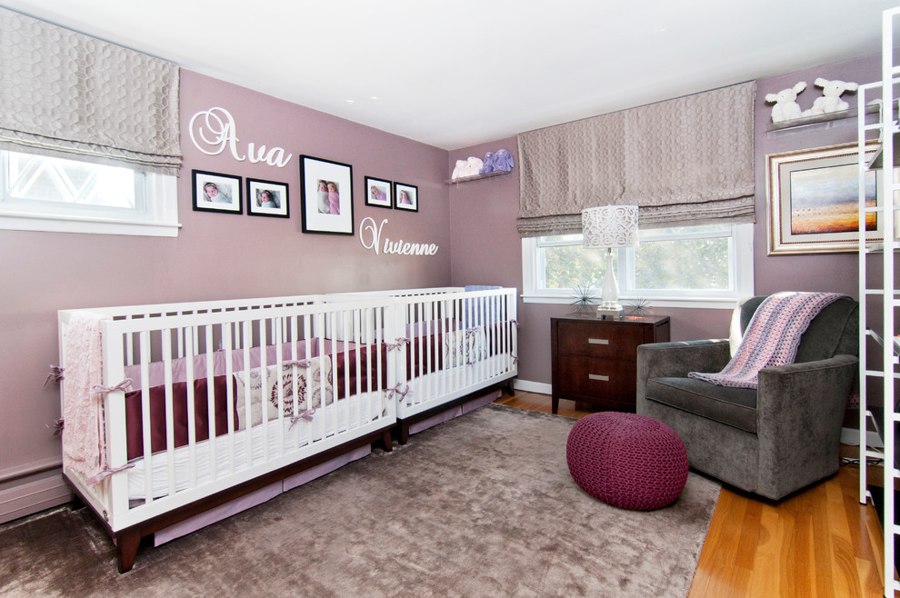 Inspiration for a medium sized contemporary nursery for girls in Other with purple walls and light hardwood flooring.