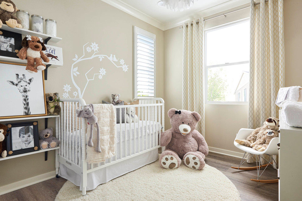 Classic gender neutral nursery in Orange County with beige walls and dark hardwood flooring.