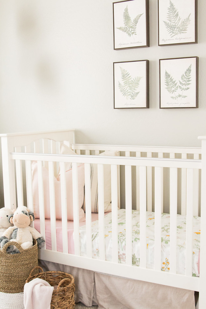 This is an example of a small traditional nursery for girls in Phoenix with grey walls, carpet and beige floors.