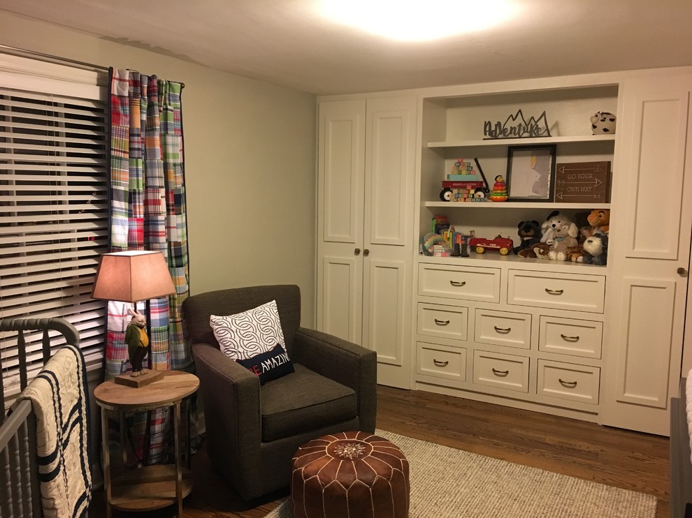 This is an example of a medium sized traditional nursery for boys in Kansas City with grey walls and dark hardwood flooring.
