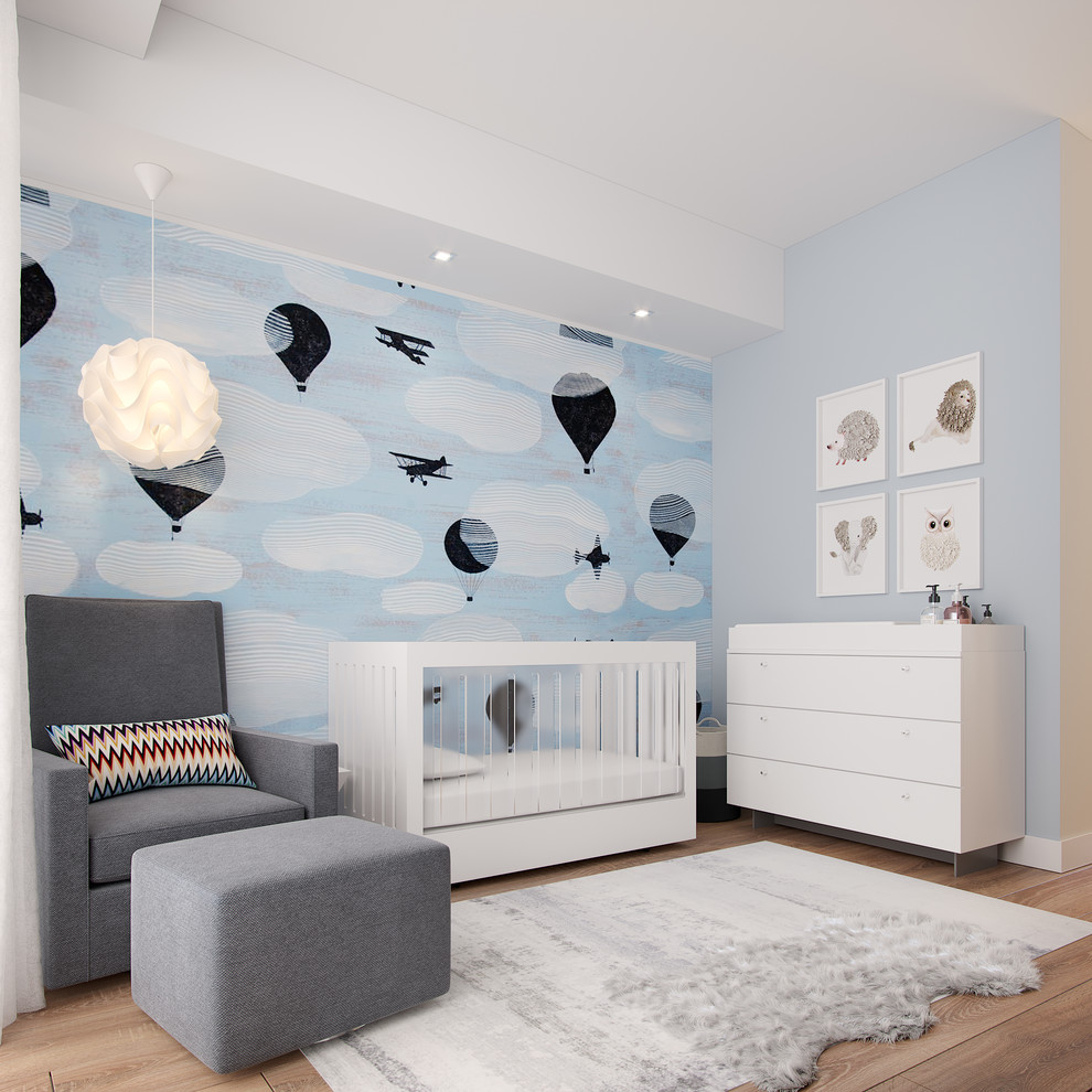 Exempel på ett modernt babyrum, med blå väggar, ljust trägolv och beiget golv