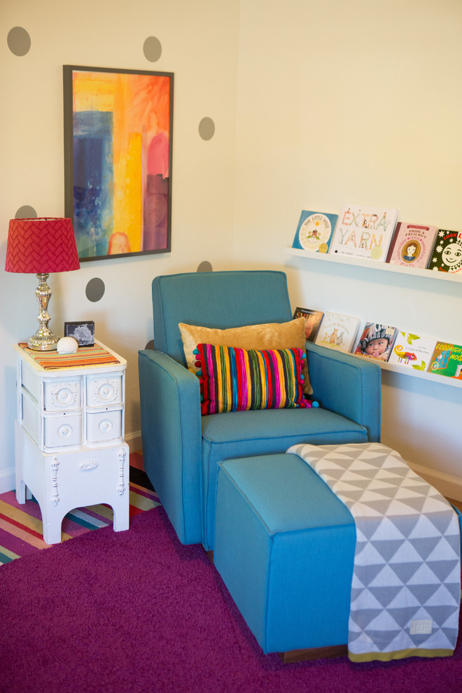 This is an example of a medium sized eclectic nursery for girls in San Diego with white walls and medium hardwood flooring.