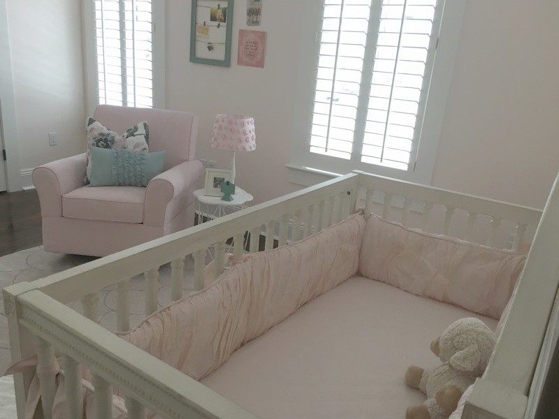 This is an example of a classic nursery for girls in New Orleans with pink walls.