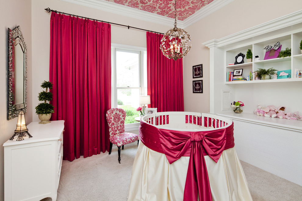 Example of a classic girl carpeted nursery design in Austin with pink walls