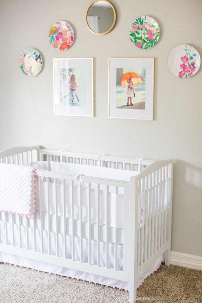 Mid-sized transitional girl carpeted nursery photo in Austin with gray walls