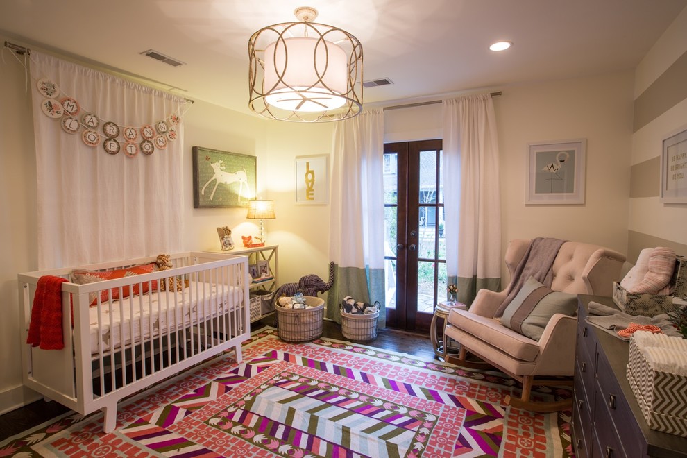 Bohemian gender neutral nursery in Charleston with beige walls and dark hardwood flooring.