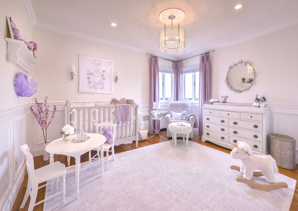 Design ideas for a medium sized classic nursery for girls in New York with white walls and carpet.