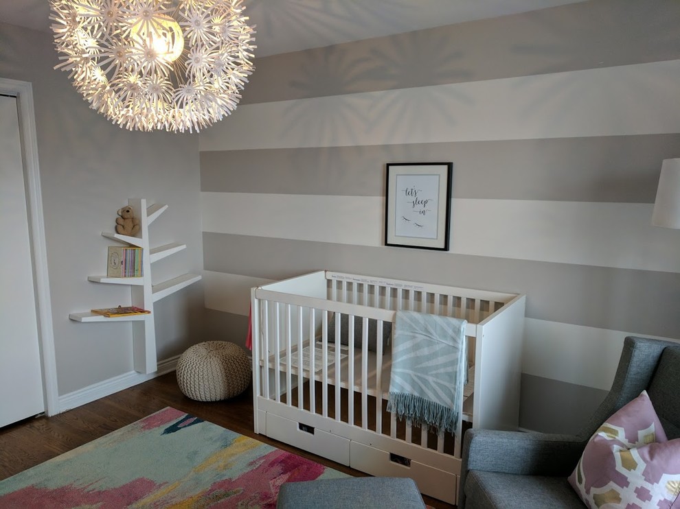 Design ideas for a medium sized modern gender neutral nursery in Toronto with grey walls and medium hardwood flooring.