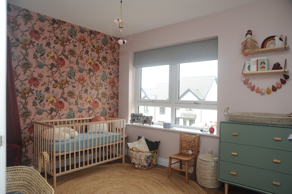 Inspiration for an eclectic nursery for girls in Edinburgh with multi-coloured walls, medium hardwood flooring, brown floors and a feature wall.