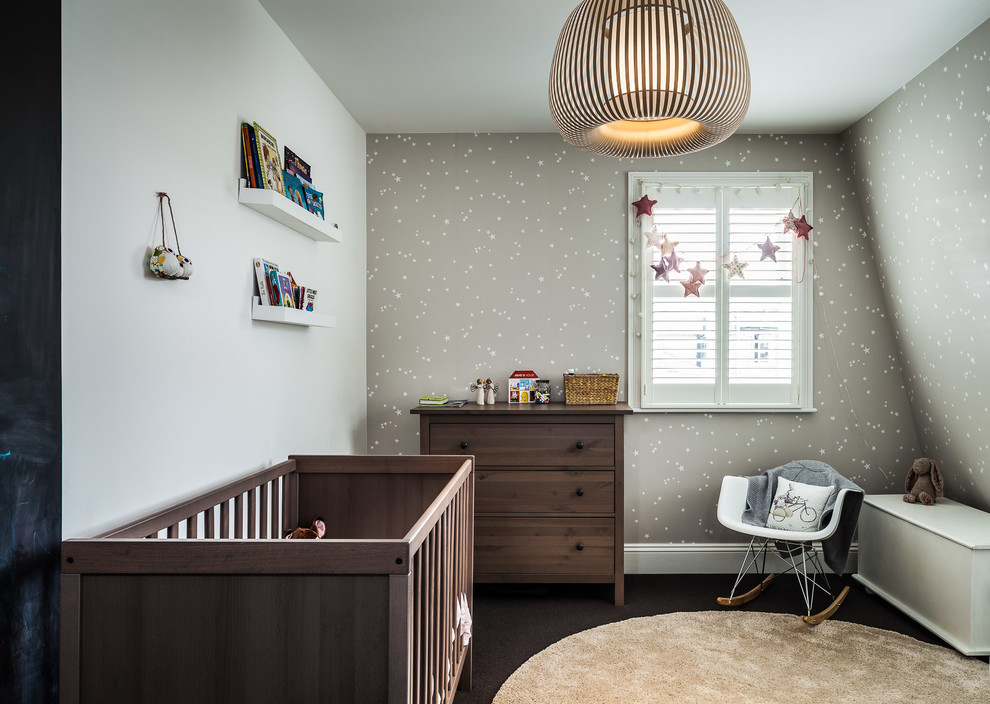 Traditional gender neutral nursery in London with grey walls, carpet and brown floors.